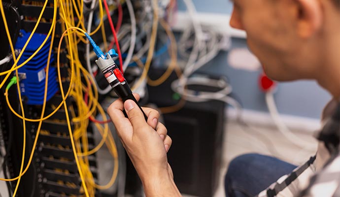 professional electrician engineer man testing optical fiber